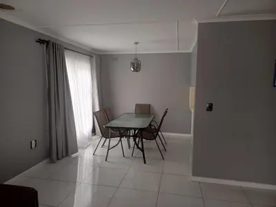 a dining room with a table and chairs at Capetown Adilo Villa in Cape Town