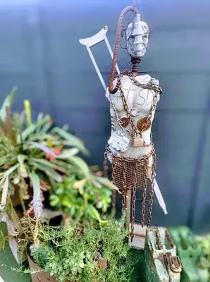 a figurine of a person standing in a garden at Anna's Studio in Strand