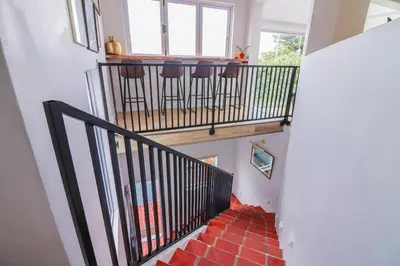 a stairway with stools on the top of a building at Blou Huis in Hermanus