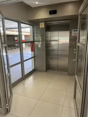 an elevator lobby in an airport with glass doors at 144 Mayfair Discerning Luxury and Ultimate Comfort in Cape Town