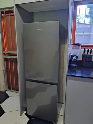 a stainless steel refrigerator in a kitchen next to a window at Capetown Adilo Villa 2 in Cape Town