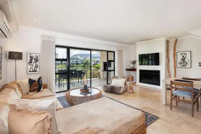a living room with a couch and a table at Pearl Valley Golf Estate, Cedar Point 4A in Simondium