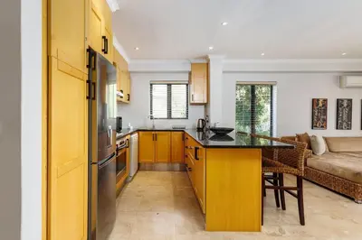 a kitchen with yellow cabinets and a counter top at Pearl Valley Golf Estate, Cedar Point 4A in Simondium