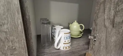 a door with some cups and a glass jar at Cozy Quarters Self-Catering Accommodation in Bellville