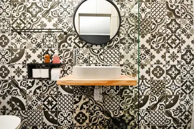 a bathroom with black and white tiles and a mirror at Velvet & Bloom Cottage in Durbanville in Oakdale
