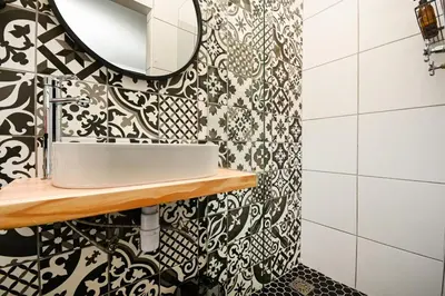 a bathroom with a sink and a mirror at Velvet & Bloom Cottage in Durbanville in Oakdale