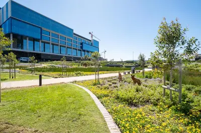 a building with a garden in front of a building at 827 Riverlands - Studio Apartment with Parking in Cape Town