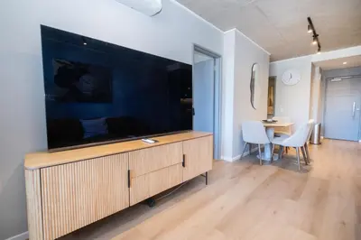 a living room with a large flat screen tv at 312 Riverlands - Lux 2 bedroom Apartment in Cape Town