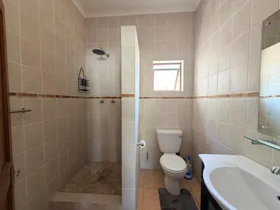 a bathroom with a toilet and a sink at Le Grec Wine Tram Apartment #2 in Franschhoek