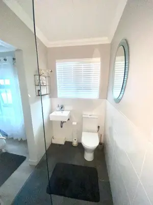 a bathroom with a toilet and a sink at Living Lite in Kleinmond