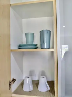 two bowls and plates are sitting on a shelf at The Botanic Venus in Paarl