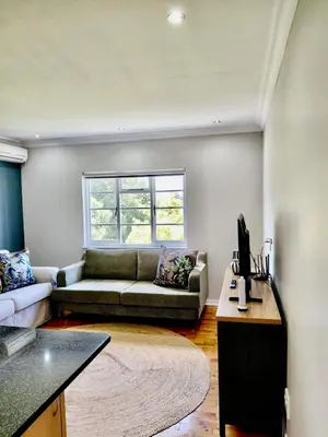 a living room with a couch and a table at The Botanic Venus in Paarl