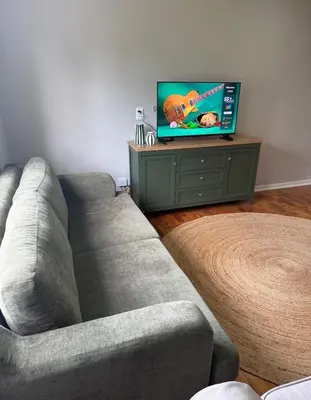 a living room with a couch and a flat screen tv at The Botanic Venus in Paarl