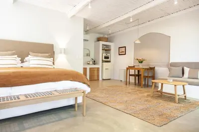 a bedroom with a bed and a living room at The Oak Cottage in Wellington