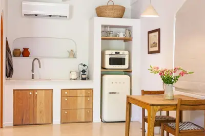 a kitchen with a small table and a microwave at The Oak Cottage in Wellington