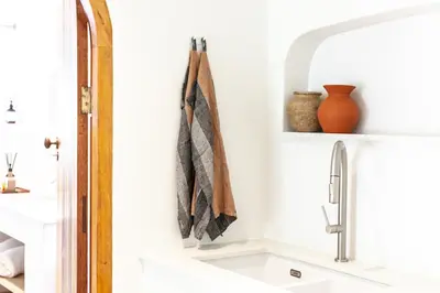 a kitchen counter with a sink and a towel at The Oak Cottage in Wellington