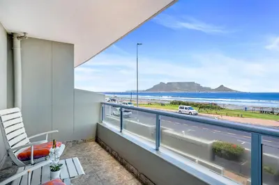 a balcony with a view of the beach at Sea Spray Views in Cape Town