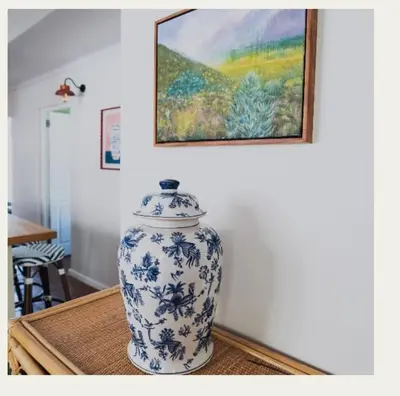 a blue and white vase sitting on a table at Kerala Cottage - farm charm inspired self-catering