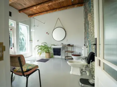 a bathroom with a toilet and a mirror at Drakenskloof - Exclusive-Use Mountain Homestead