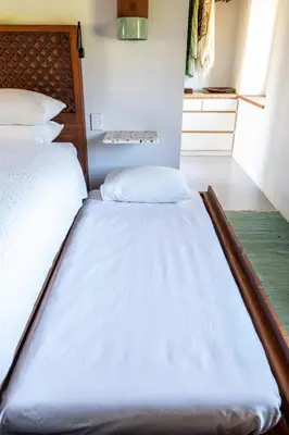 a large bed in a room with avertisementatronatronstrationstration at Drakenskloof - Exclusive-Use Mountain Homestead