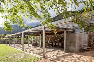 an outdoor patio with a table and chairs at Drakenskloof - Exclusive-Use Mountain Homestead