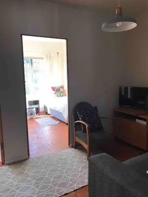 a room with a bedroom with a bed and a mirror at Newly renovated Stellies 2 Bed apt in heart of Stellies! in Stellenbosch