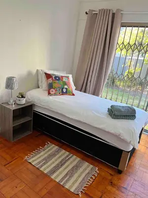 a bed in a room with a window at Newly renovated Stellies 2 Bed apt in heart of Stellies! in Stellenbosch