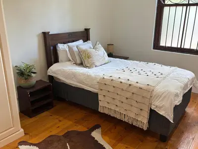 a bedroom with a bed with pillows on it at Heldeberg 6 in Stellenbosch