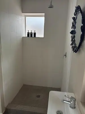 a white bathroom with a sink and a window at Heldeberg 6 in Stellenbosch
