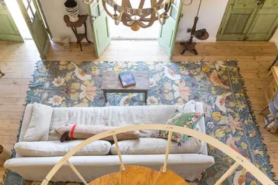 a living room with a couch and a table at Authentic and Charming French-inspired Cottage in Franschhoek