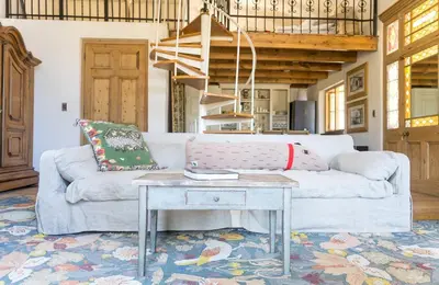 a living room with a couch and a table at Authentic and Charming French-inspired Cottage in Franschhoek