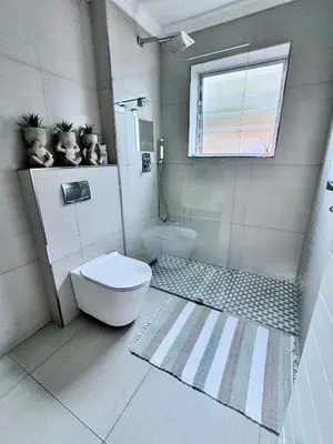 a bathroom with a toilet and a window at 3at33 CT in Cape Town
