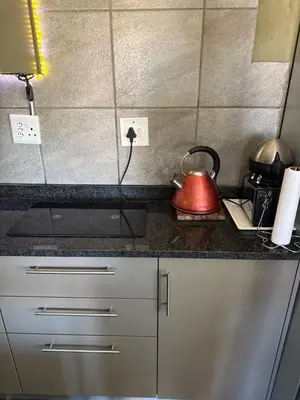 a kitchen counter with a tea kettle on it at Balcony mountain views free fibre-wifi aircon and parking in Wellington