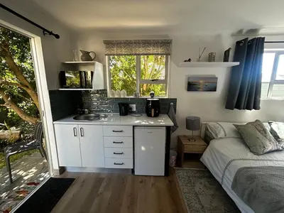 a kitchen with a sink and a bed in a room at Dove Cottage in Oakdale