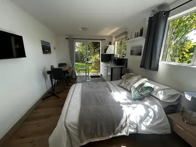 a bedroom with a bed and a desk and a window at Dove Cottage in Oakdale