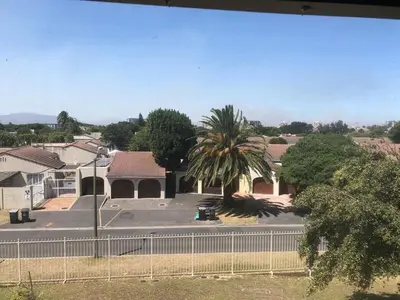 a house with a palm tree in a parking lot at Central and close to the beach in Cape Town