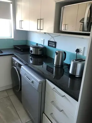 a kitchen with two pots and pans on a stove at Central and close to the beach in Cape Town