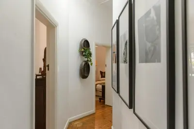 a hallway with white walls and pictures on the walls at Am Flus- at the river in Stellenbosch