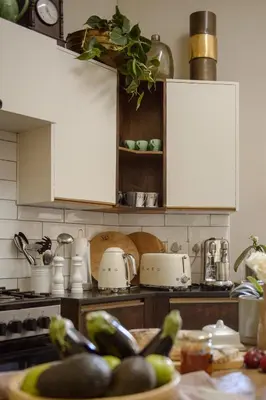 a kitchen with white cabinets and a counter top at Am Flus- at the river in Stellenbosch