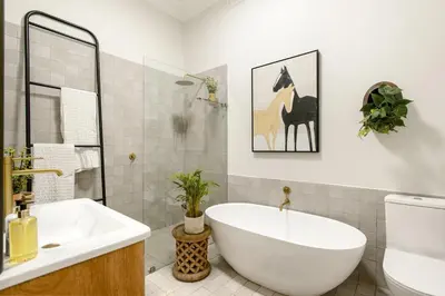 a bathroom with a white tub and a sink at Am Flus- at the river in Stellenbosch