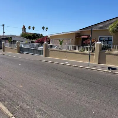 an empty street with a fence on the side of a road at Home of peace self catering accommodations