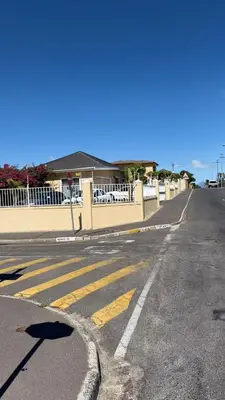 an empty street with a white fence and a road at Home of peace self catering accommodations