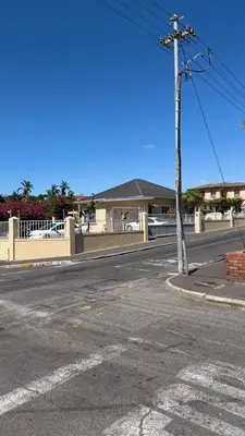 an intersection of an empty street with a white fence at Home of peace self catering accommodations