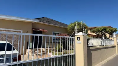 a fence in front of a house with a gate at Home of peace self catering accommodations