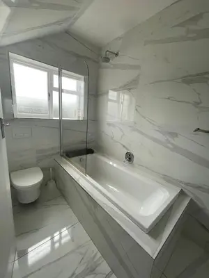a white bathroom with a sink and a toilet at Salty Leaves in Hermanus