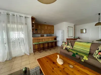 a living room with a couch and a table at Salty Leaves in Hermanus