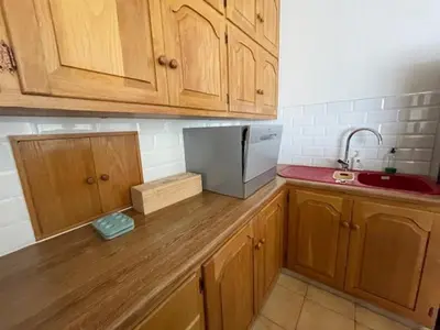 a kitchen with wooden cabinets and a counter top at Salty Leaves in Hermanus