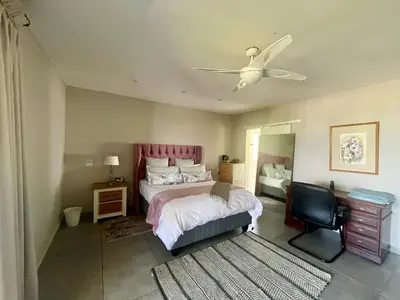 a bedroom with a bed and a ceiling fan at Paarl View House in Paarl