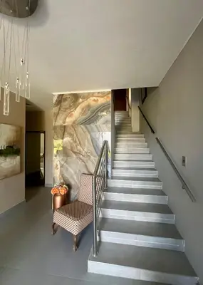 a staircase in a house with a painting on the wall at Paarl View House in Paarl