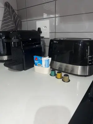 a kitchen counter with a toaster oven and a microwave at Modern stay overlooking Durbanville wine country in Durbanville
